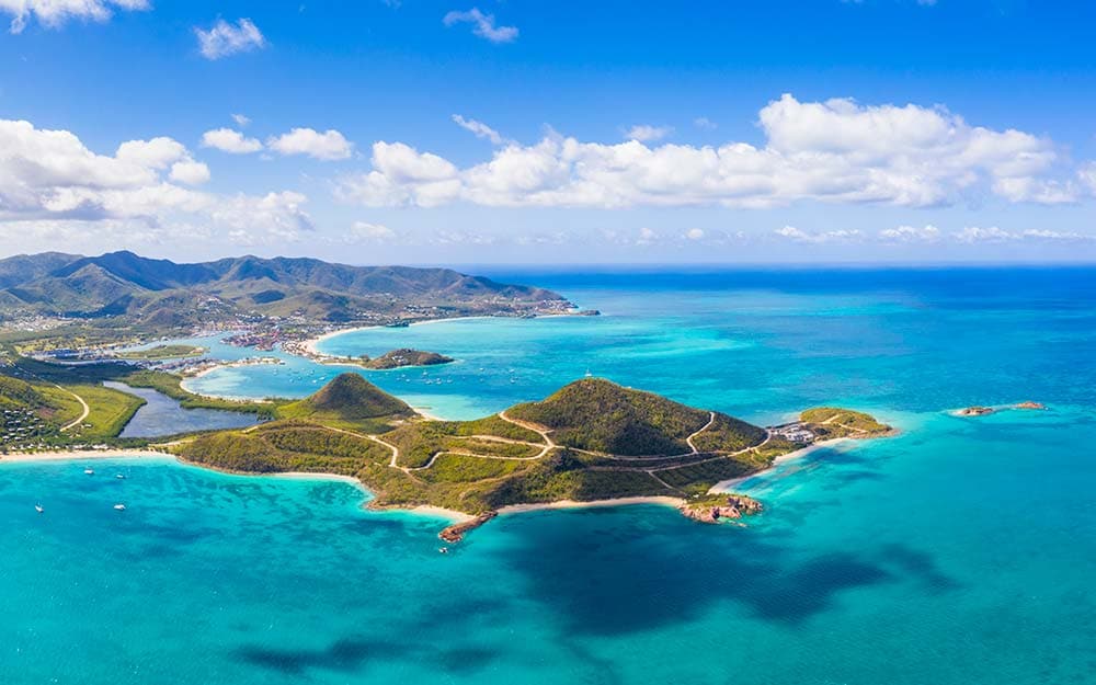 Aerial view of Antigua's turquoise bays and green hills